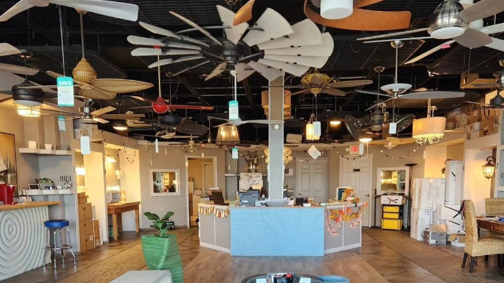 Modern interior design showroom with ceiling fans, furniture, and decor.