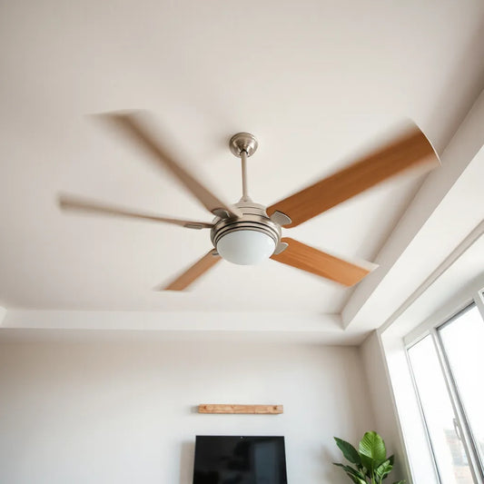 Modern living room ceiling fan with visible blades spinning in soft daylight