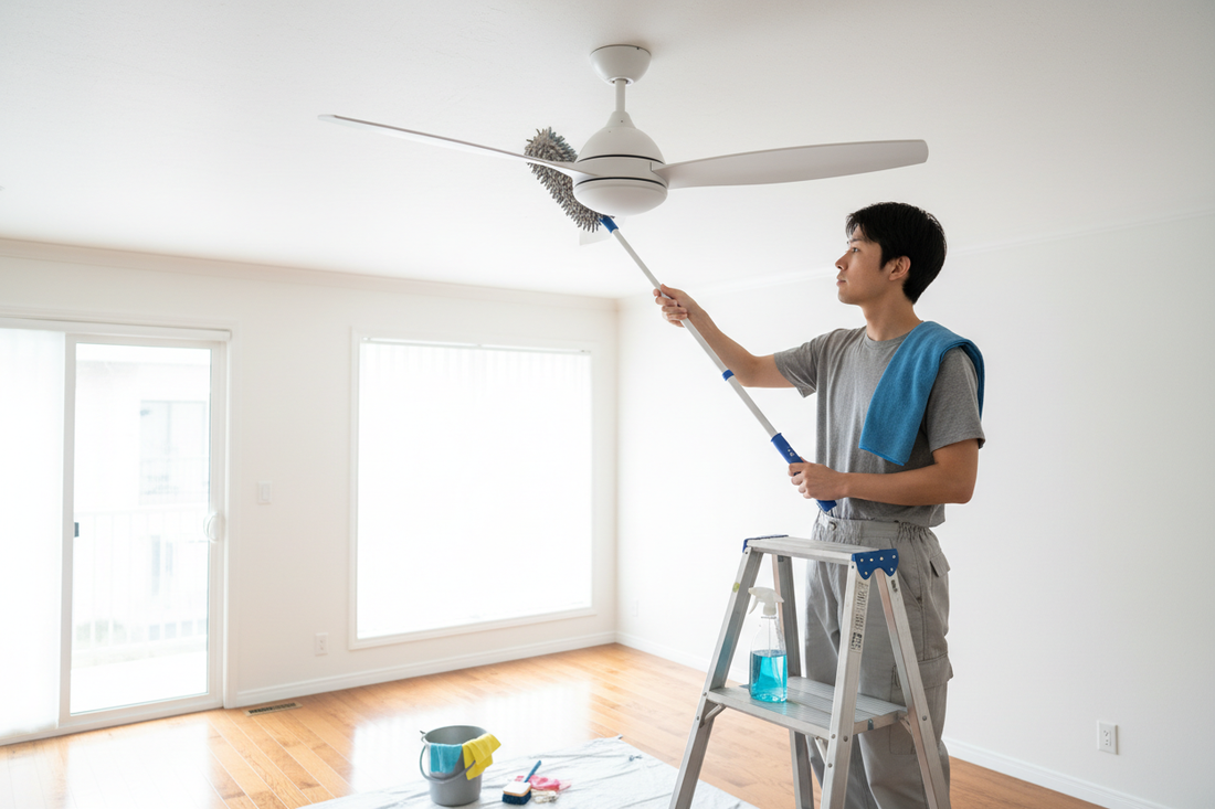 A person cleaning a ceiling fan